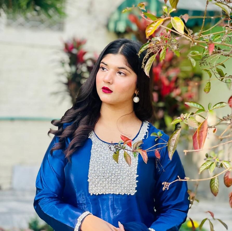 Model wearing a blue floral outfit